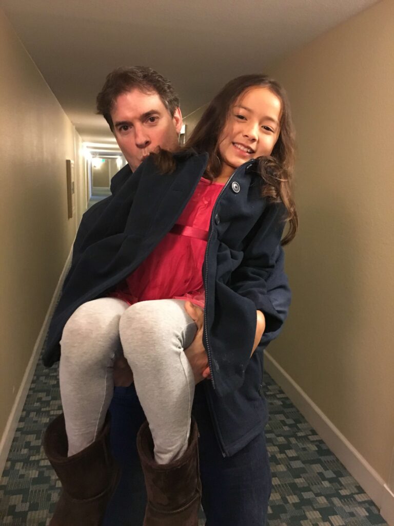 Joseph Rosario holds up his daughter Charlotte