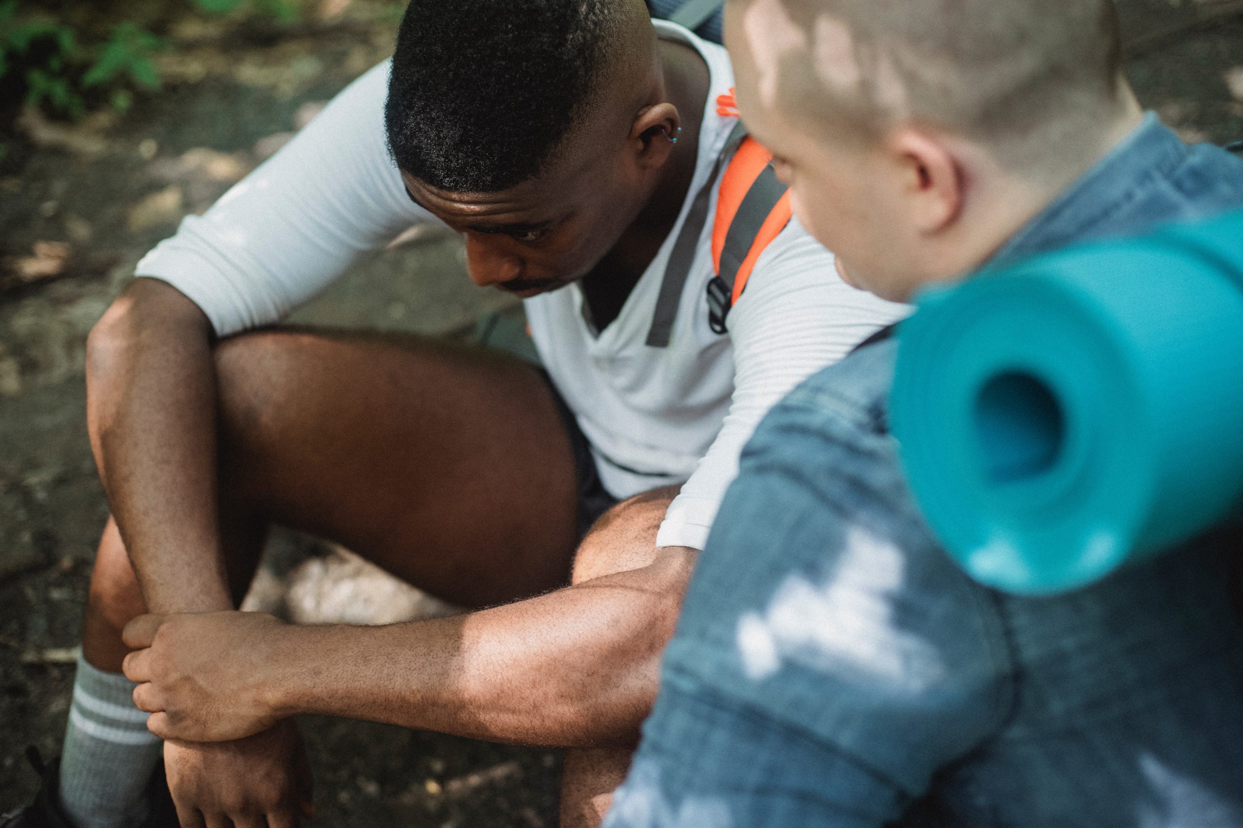 Man consoling his friend after experiencing discrimination