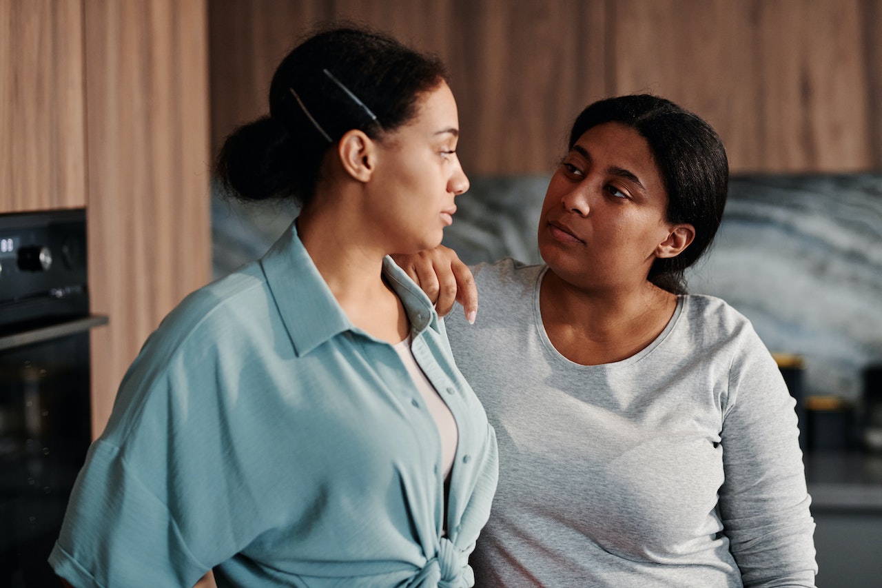 Latine mother daughter conversation taking place in the kitchen