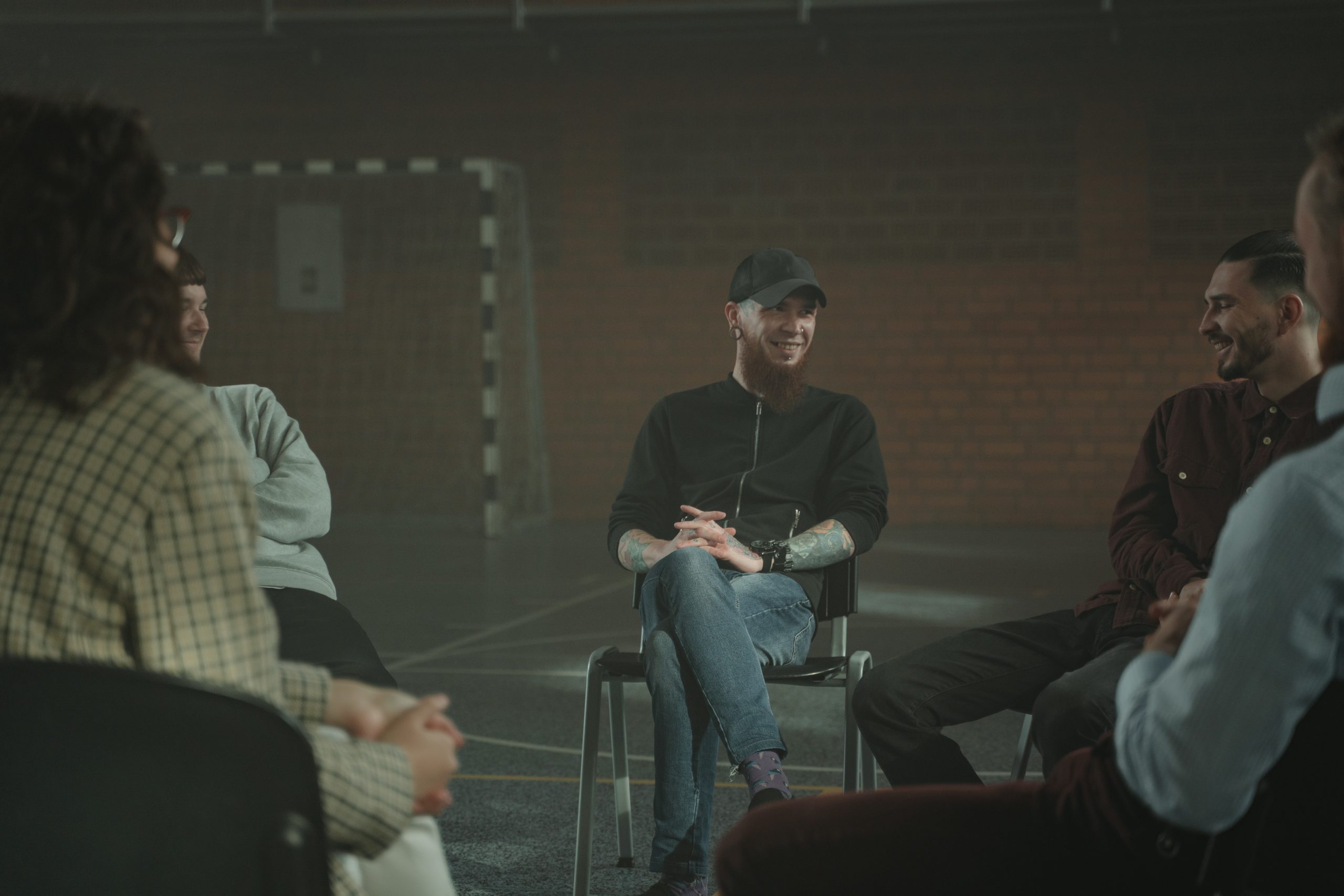men and women sitting and talking at a support group meeting